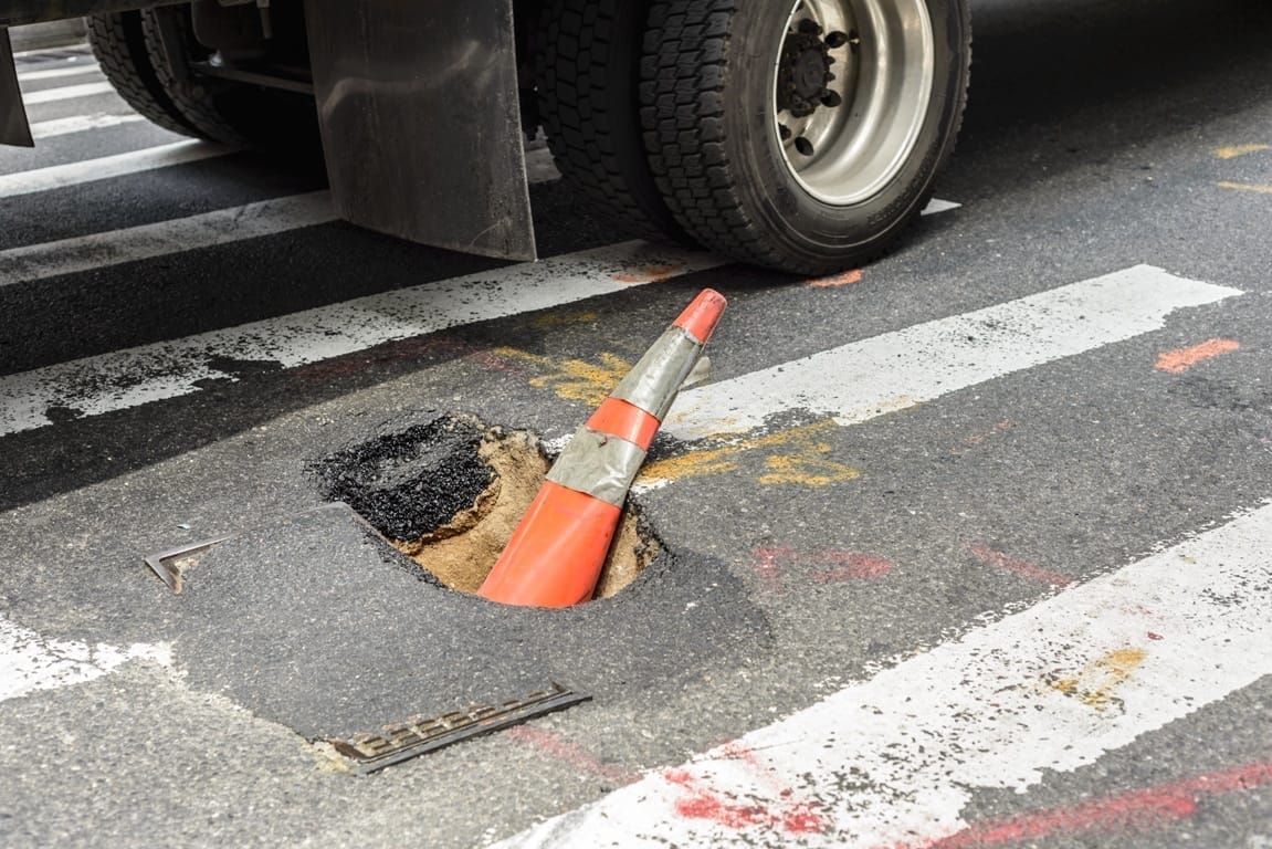 pothole with a cone in it