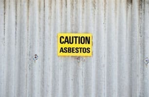 yellow caution asbestos sign