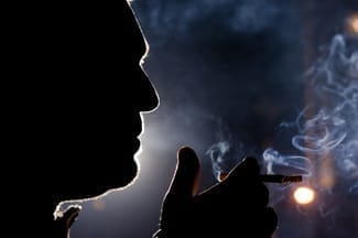 man smoking at night