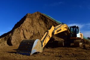 mining excavator by dirt pile