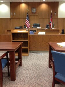 courtroom with flags and desks