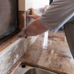 worker exposing himself to silicosis by installing stone slab