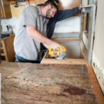 worker installing stone countertop